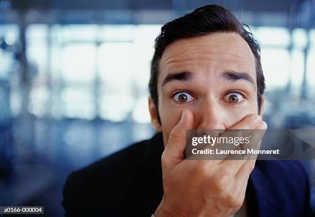 businessman covering mouth - suprised stock pictures, royalty-free photos & images