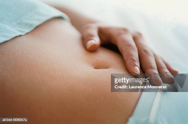 woman's stomach - tocar fotografías e imágenes de stock