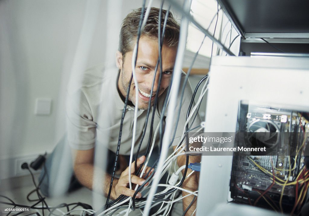 Man Adjusting Computer Cables