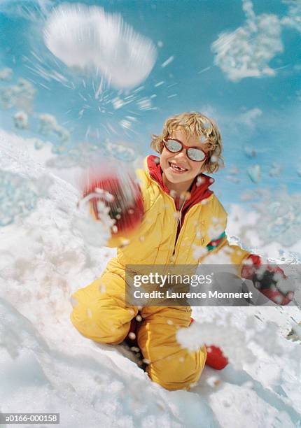 boy throwing snowballs - snowball stock pictures, royalty-free photos & images
