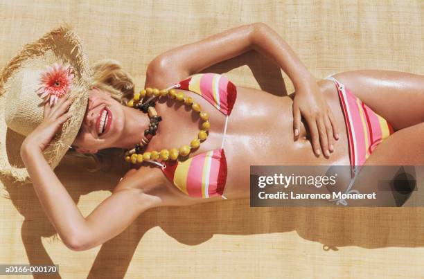 young woman sunbathing - biquini fotografías e imágenes de stock