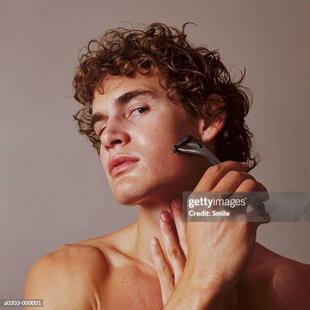 man shaving - かみそり ストックフォトと画像