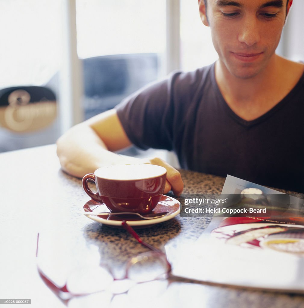 Man Sitting in Cafe