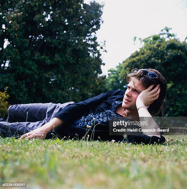 man relaxing on grass - heidi coppock beard stock pictures, royalty-free photos & images