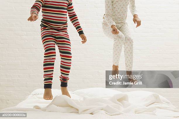 children's legs jumping on bed - children jumping bed stock pictures, royalty-free photos & images