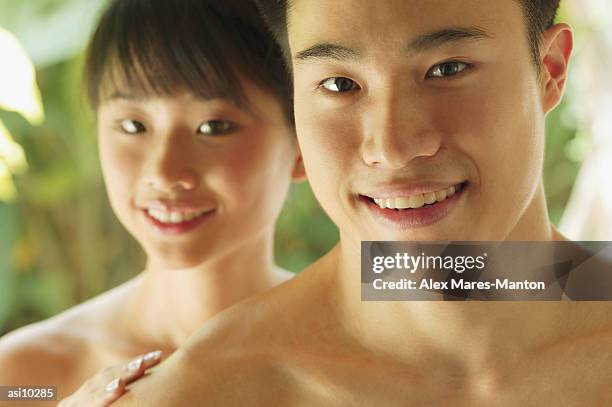 couple looking at camera, smiling - backed stock pictures, royalty-free photos & images