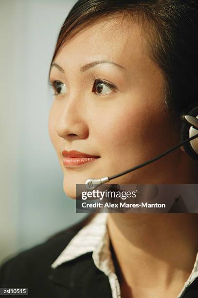 young woman wearing hands-free device, looking away - duty free 個照片及圖片檔