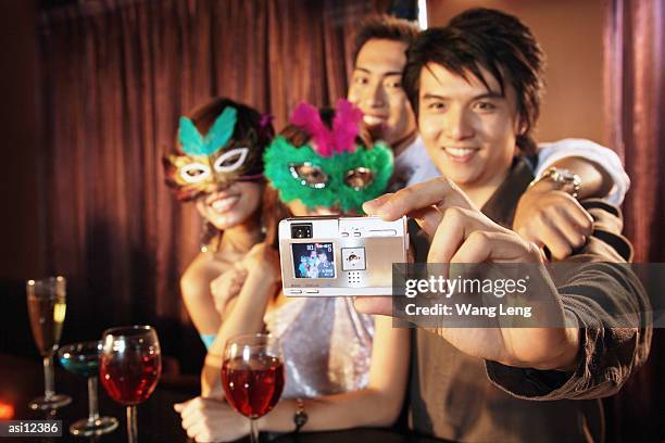 couples with masks taking a picture with camera - camera picture ストックフォトと画像