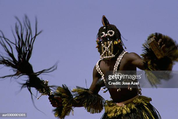 a dogon man in his traditional costume as he dances during a celebration, africa. - celebration imagens e fotografias de stock