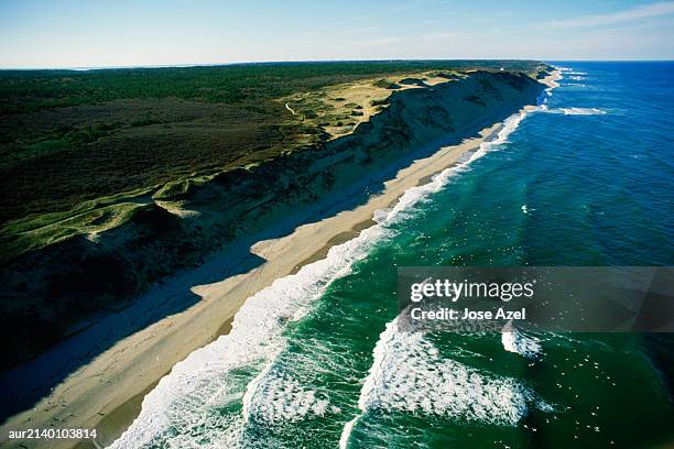 an aerial view of waves hitting the cape cod shore, massachusetts, usa. - flowing cape stock-fotos und bilder