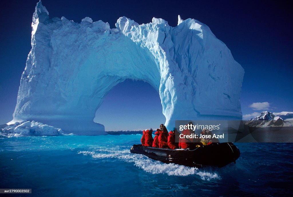 Small boat approaching icebergs near Yalour Islands, Antarctica.