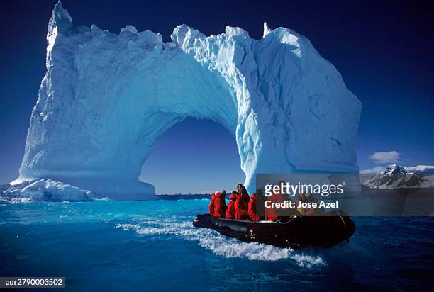 small boat approaching icebergs near yalour islands, antarctica. - antarctica boat stock pictures, royalty-free photos & images