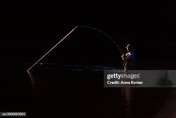 fisherman catching a fish in river, patagonia, argentina. - anna stock-fotos und bilder