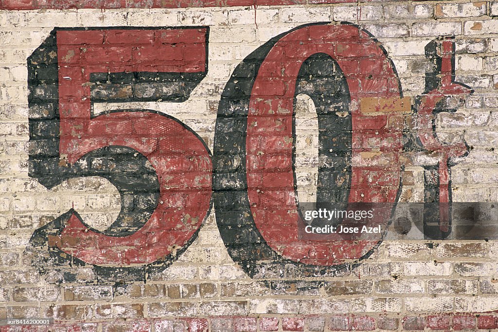 Fifty Cent sign painted on a building.