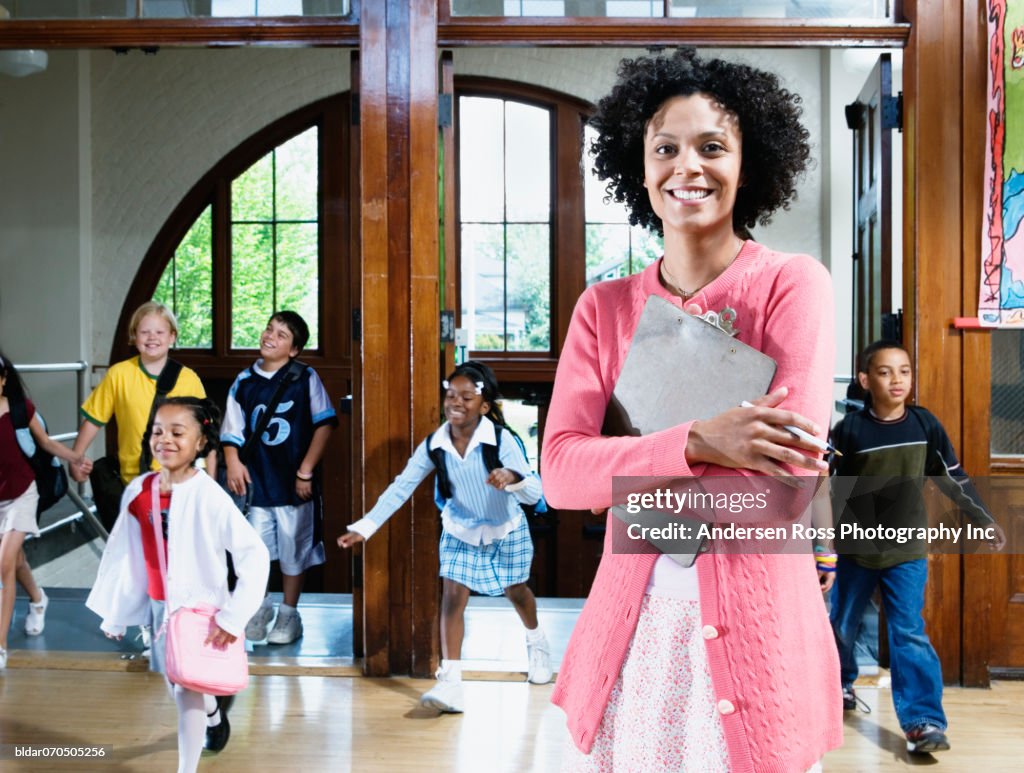 Portrait of a female teacher with her students