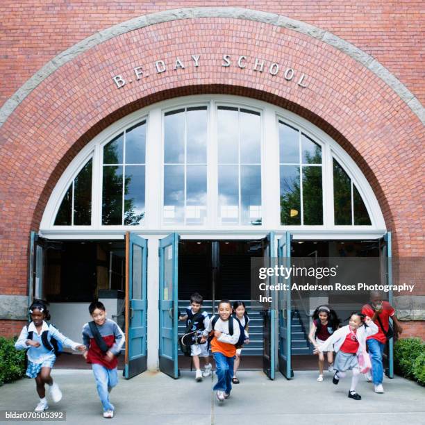 students running out of the school - school door window stock pictures, royalty-free photos & images
