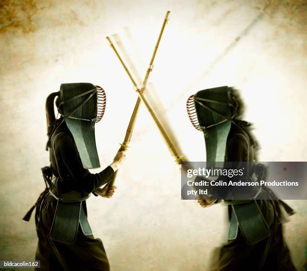 two young women in protective fencing wear fighting - aikido stock pictures, royalty-free photos & images