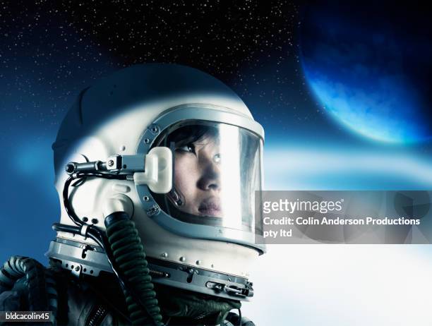 side profile of a female astronaut wearing a space helmet - astronaut helm stock pictures, royalty-free photos & images