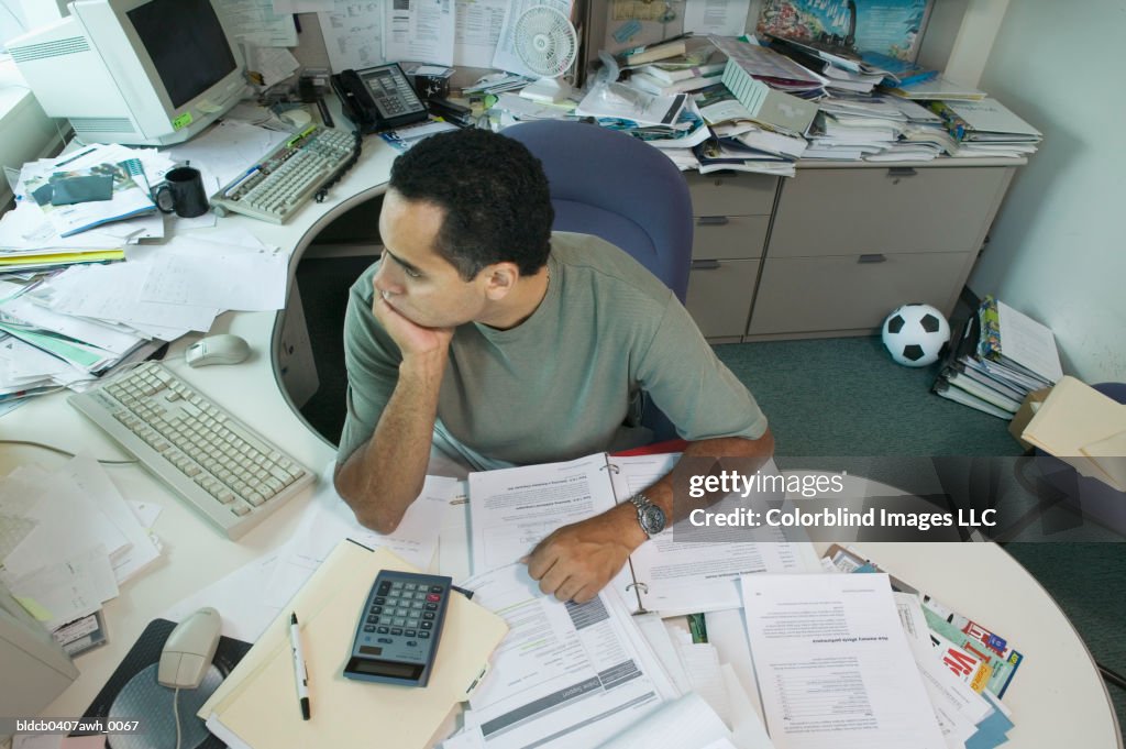 High angle view of a businessman sitting on chair with his hand on his chin