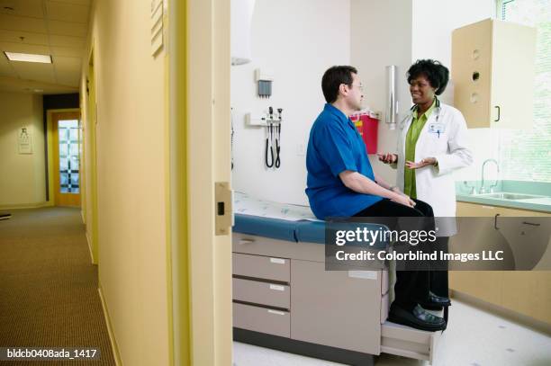 female doctor talking to a man - doctor stethoscope patient whole body stock pictures, royalty-free photos & images