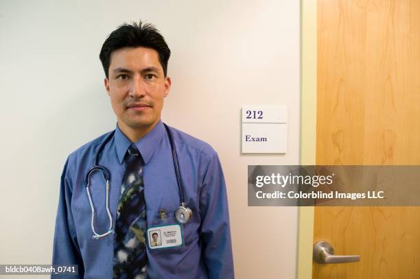 portrait of a male doctor with a stethoscope around his neck - door name plate stock pictures, royalty-free photos & images