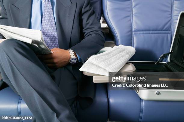 businessman traveling in am airplane - midsection stock pictures, royalty-free photos & images