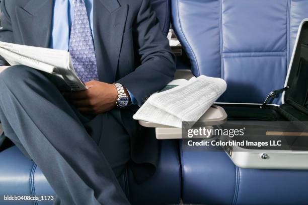 businessman traveling in am airplane - pro am imagens e fotografias de stock