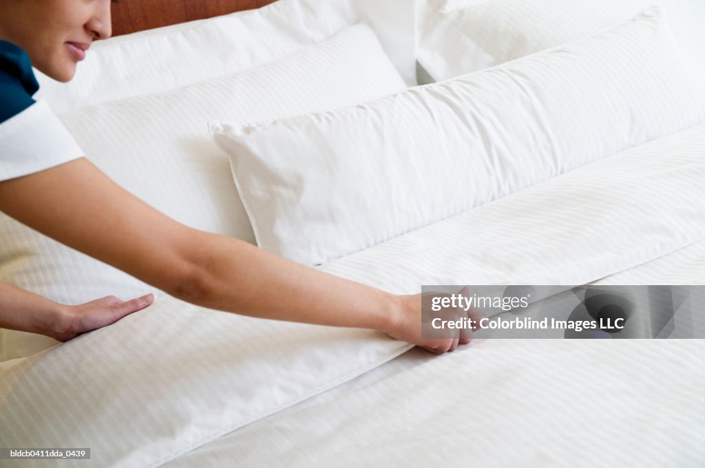 High angle view of a waitress making the bed