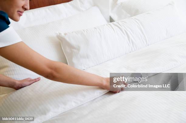 high angle view of a waitress making the bed - hotel service stock pictures, royalty-free photos & images