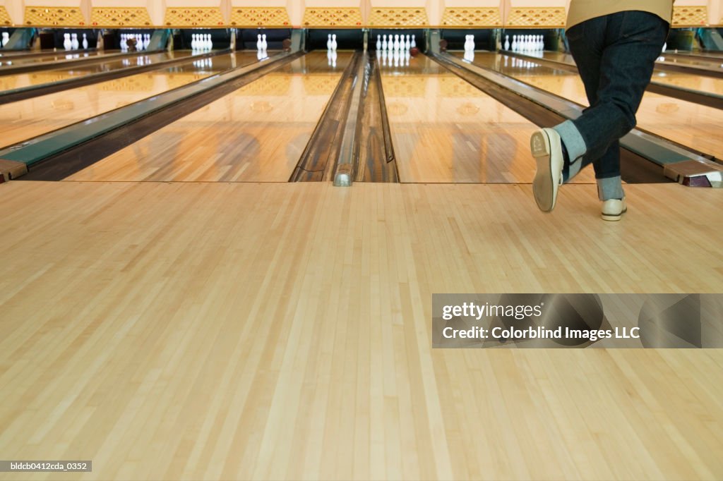 Rear view of a mid adult person bowling
