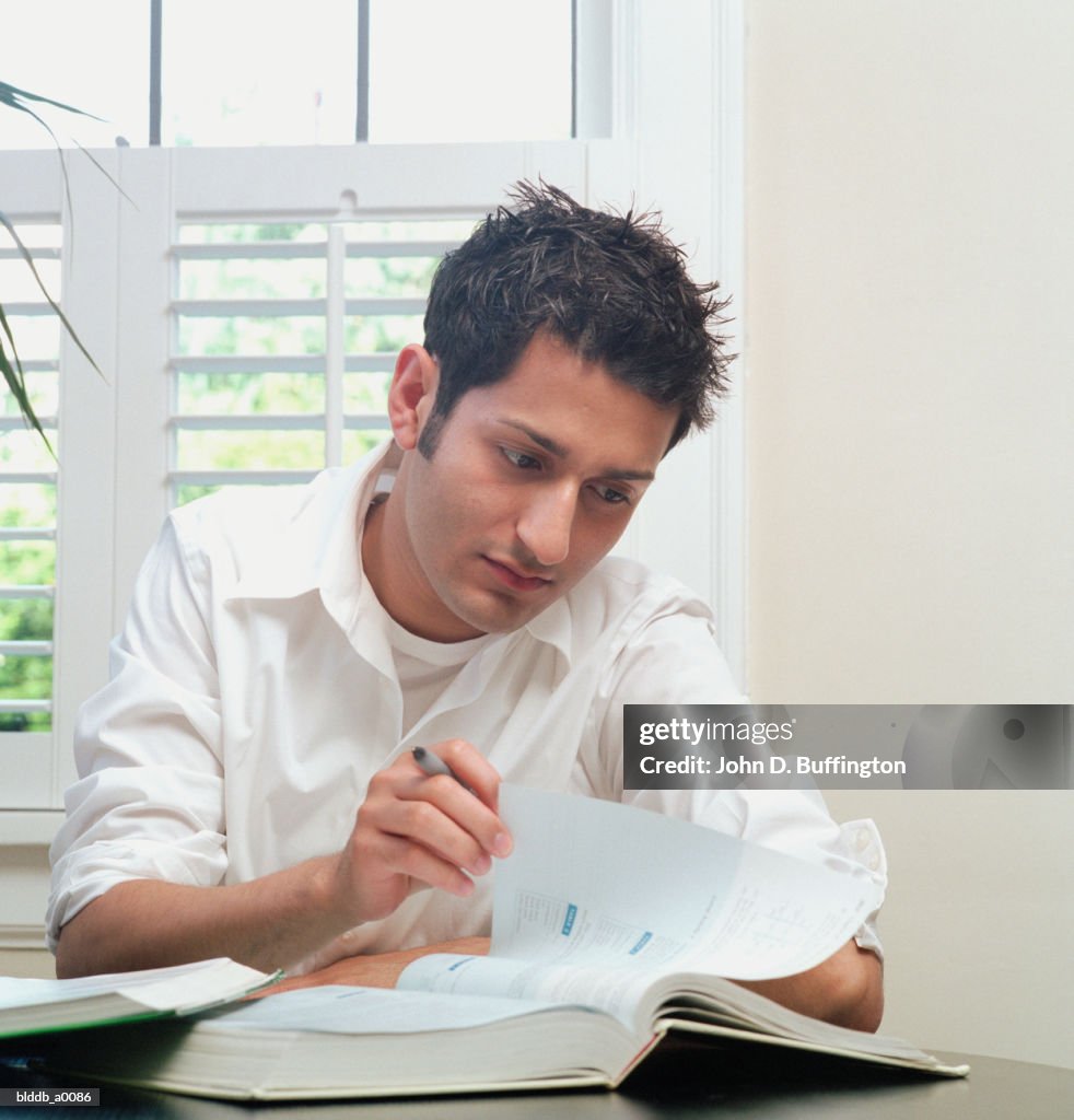 Young man sitting at a table working