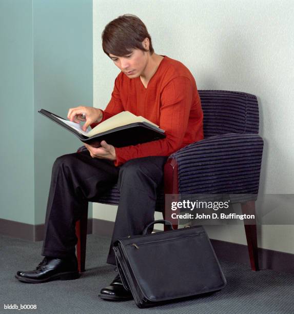 businessman looking at a file - case file folder stock-fotos und bilder