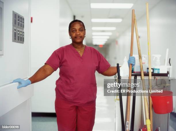 female worker in a hospital corridor - er stock-fotos und bilder