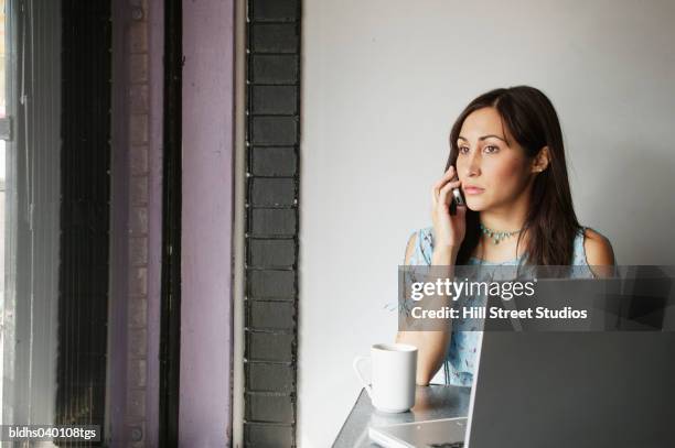 young woman talking on a mobile phone - scheitel stock-fotos und bilder