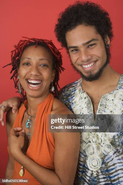 portrait of a young couple smiling - couple coloured background stock pictures, royalty-free photos & images