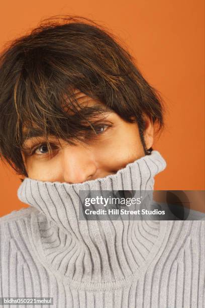 close-up of a young man covering his mouth - hill street studios stock-fotos und bilder