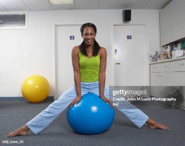 woman exercising with a fitness ball - john lund ストックフォトと画像