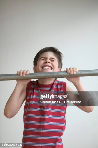 close-up of a child doing chin-ups - boys in pullups stock-fotos und bilder