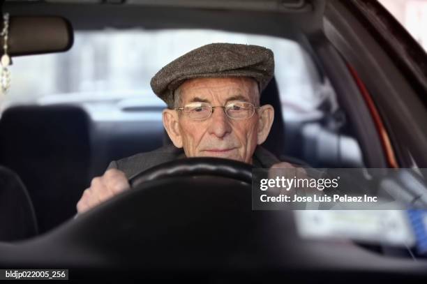 portrait of a senior man driving a car - senior men stock pictures, royalty-free photos & images