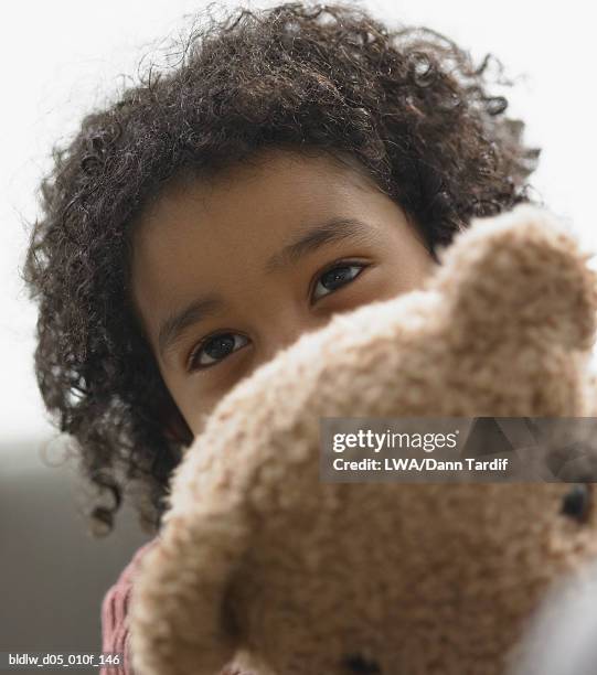 boy holding a teddy bear - lwa dann tardif stockfoto's en -beelden