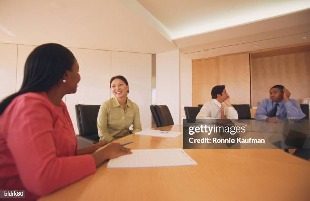 business executives seated at a table in a meeting - ronnie kaufman stockfoto's en -beelden