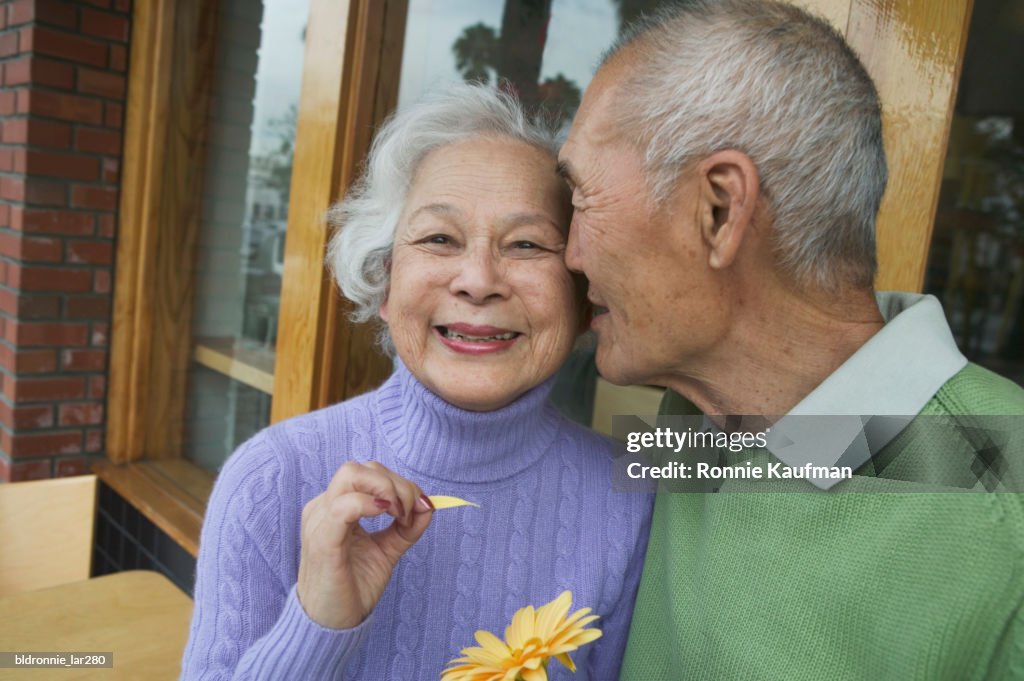 Senior man kissing a senior woman