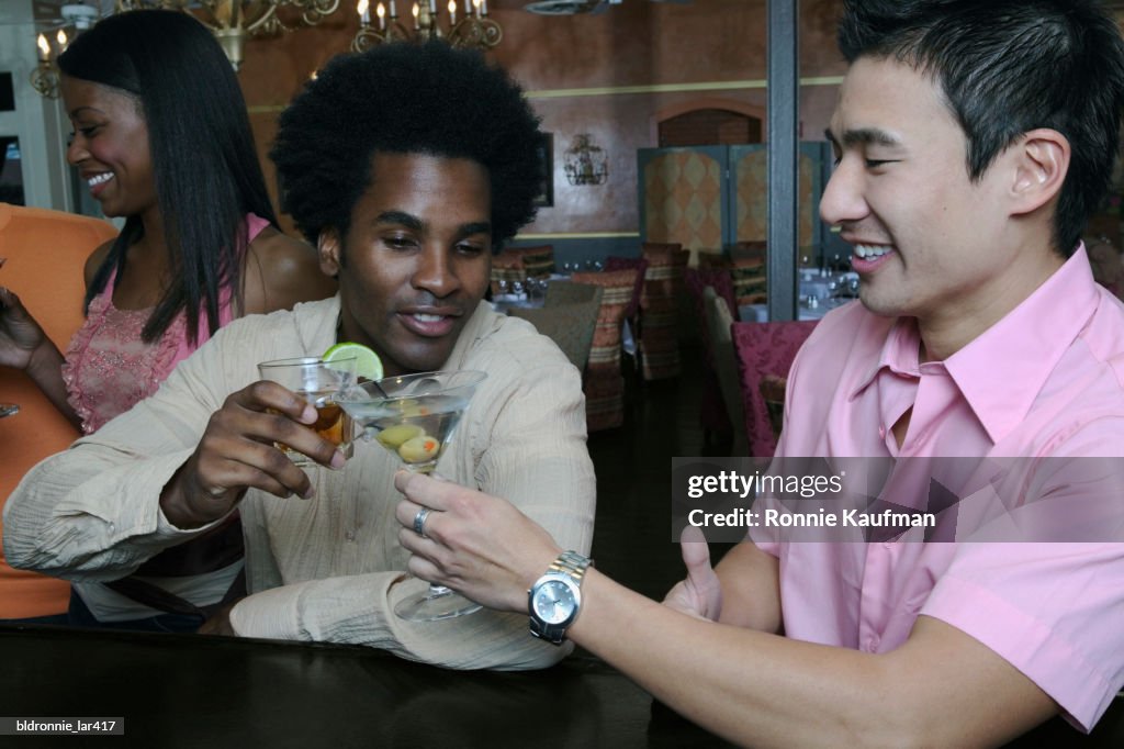 Two young men toasting in a nightclub