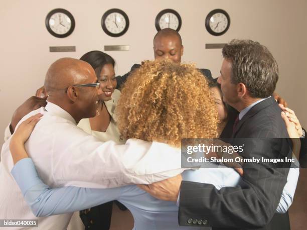 group of business executives in a huddle - private zone stock pictures, royalty-free photos & images