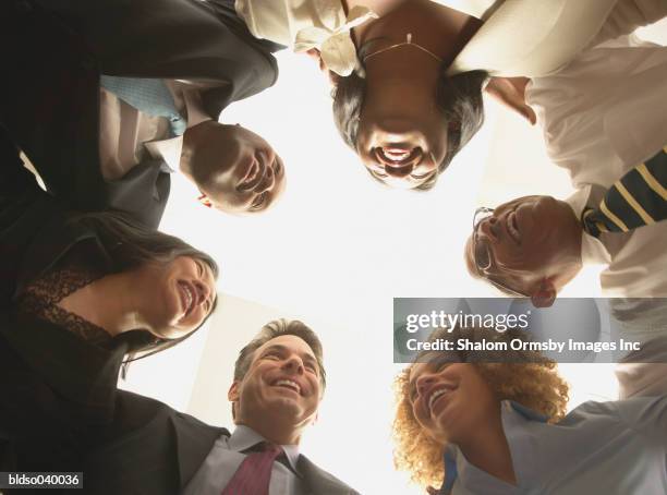 group of business executives in a huddle - private zone stock pictures, royalty-free photos & images