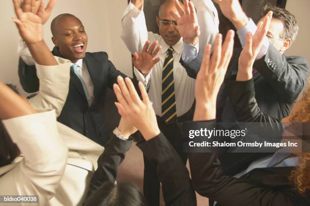 group of business executives in a huddle - private zone stock pictures, royalty-free photos & images