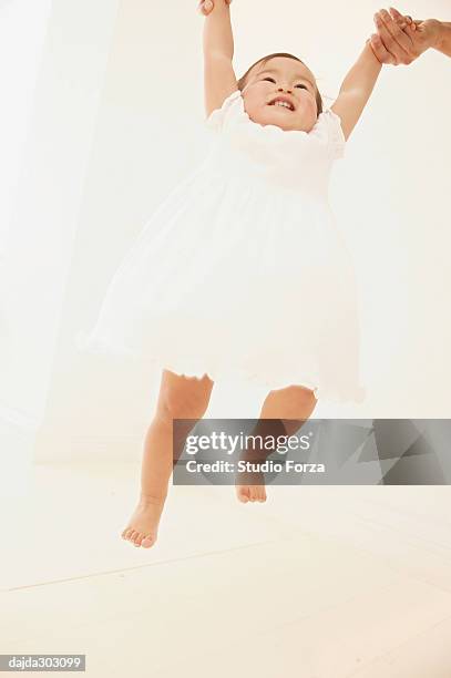 father holding up his daughter - forza fotografías e imágenes de stock