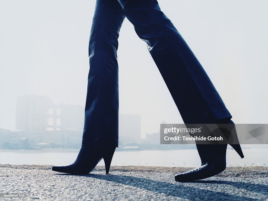 Woman walking on pavement