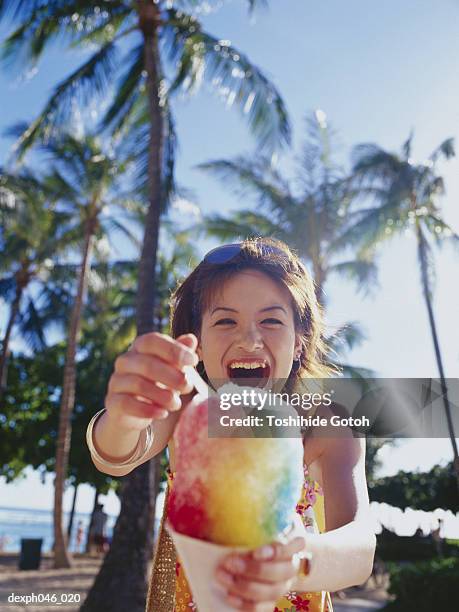 young woman holding shaved ice - shaved ice stockfoto's en -beelden