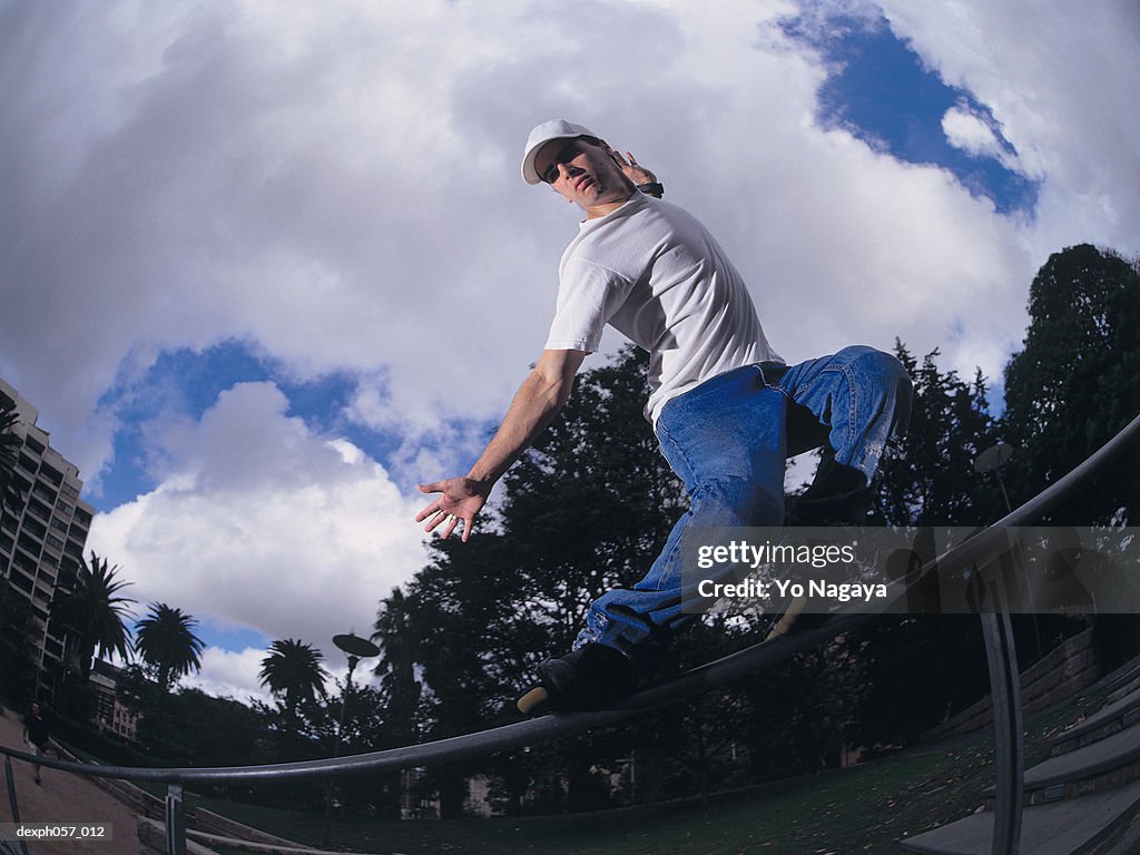 In-line skater performing stunt on railing